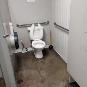 A clean bathroom featuring a white toilet and a modern sink against a neutral wall.