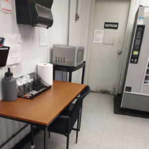A small office featuring a desk and a microwave, creating a functional workspace.